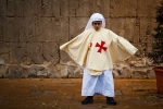 Holy Week Procession, a boy waits after the procession, Sicily, Italy 2009